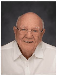 A man with glasses and a white shirt